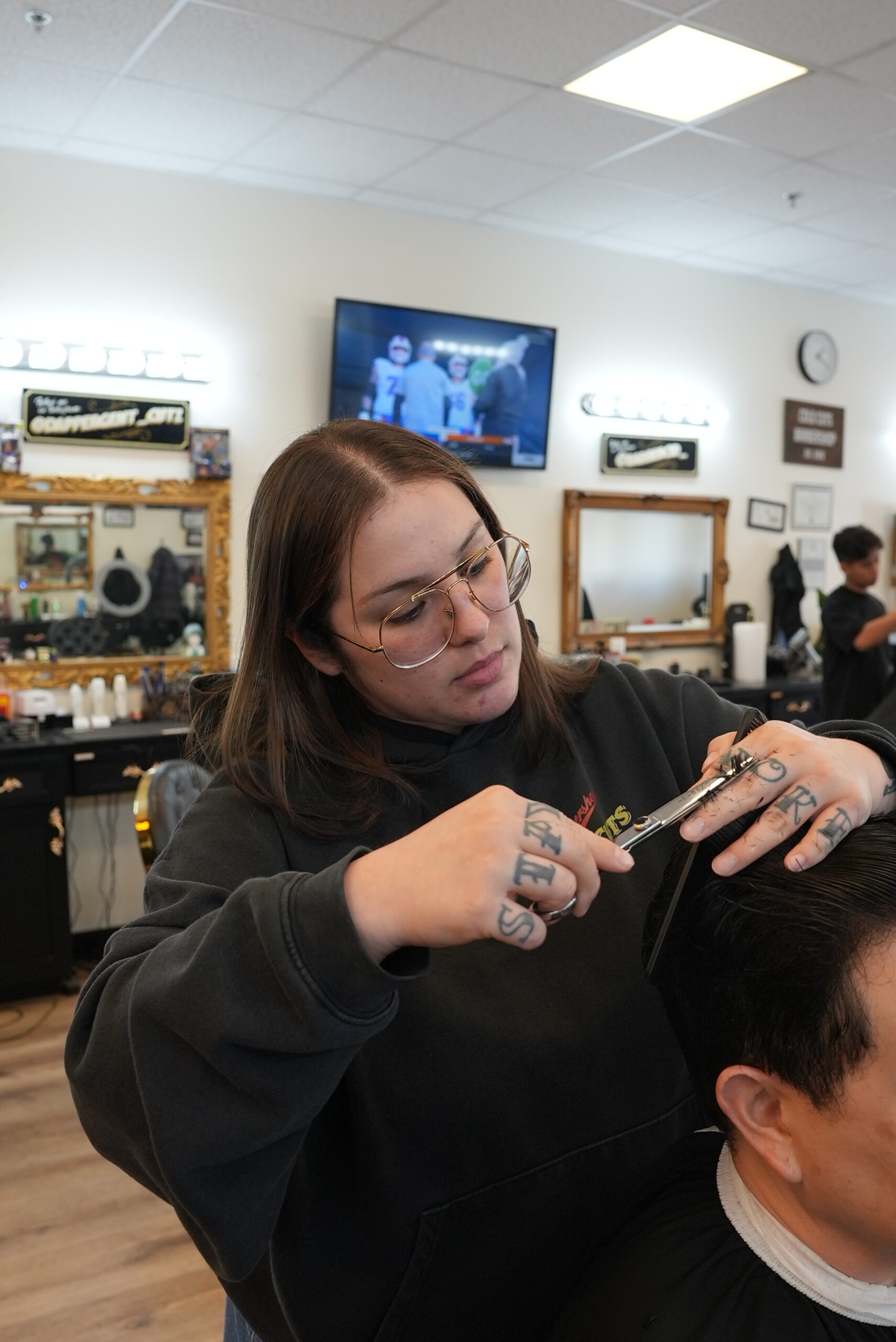 Cold Cuts Barbershop Jaszy a.k.a Jaszyt the barber lining up a client